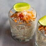 Två glas med morotskaka overnight oats toppade med lime och riven morot.