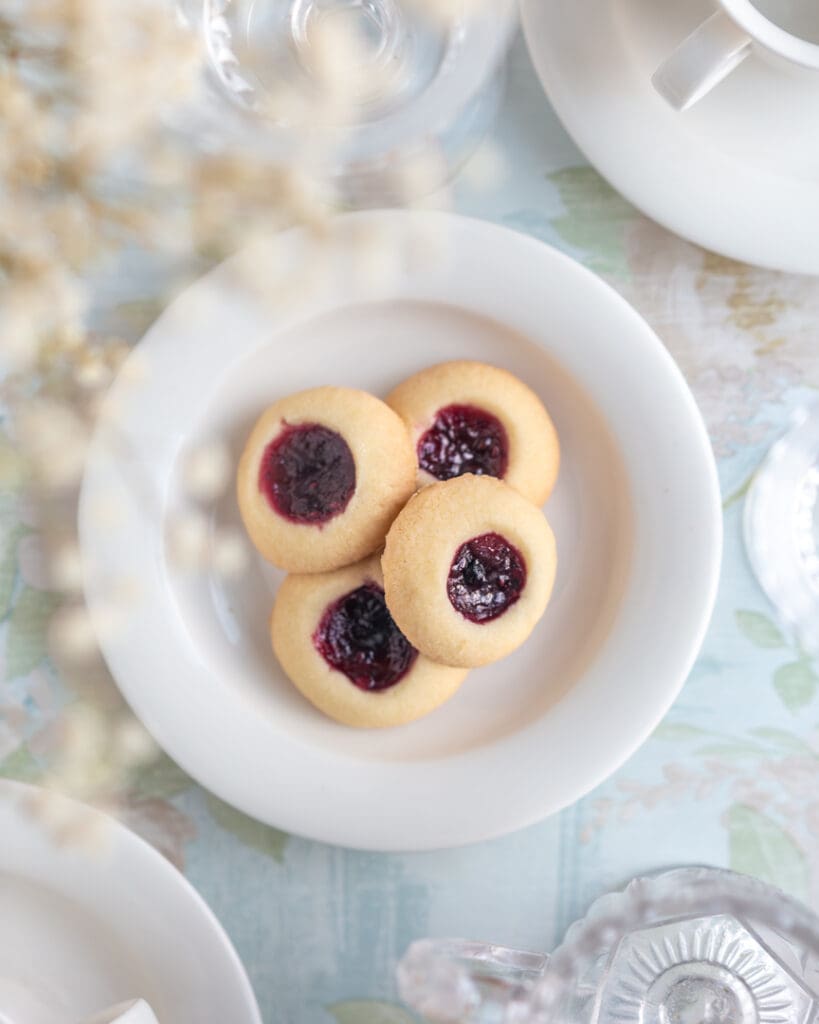 Glutenfria kolakakor 10 Fyra syltgrottor med hallonsylt på en vit tallrik.