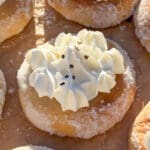 En solbullesemla med vispgrädde på toppen, placerad på en bakplåt.