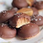 Dumlebiskvier täckta med choklad och strössel av havssalt på en tallrik.