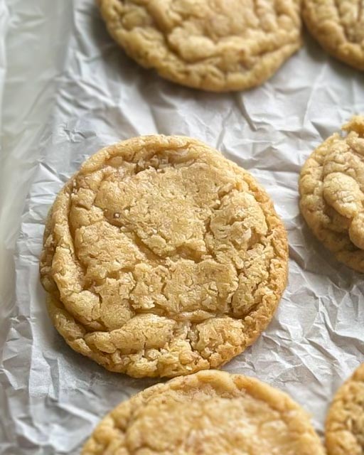 Foot long lemon cookie 9 Två kokoscookies placerade på ett bakplåtspapper med en lätt gyllene yta.